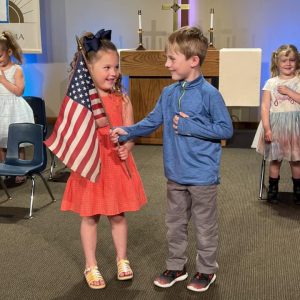 students-with-flag-gloryland-preschool
